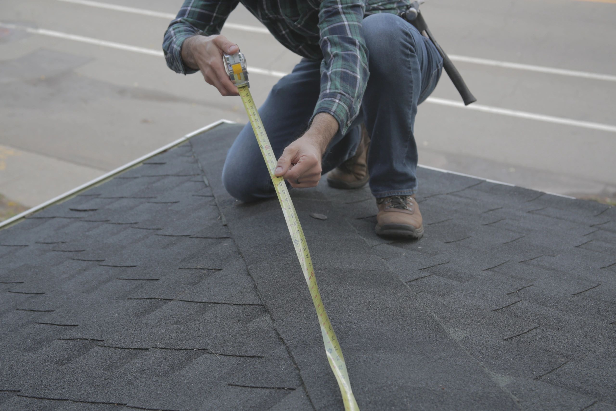 Roofer measuring a residential roof